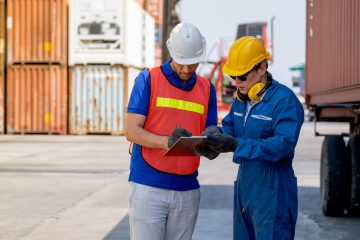 cargo-container-worker-and-engineer-discuss-togeth-2023-11-27-05-07-31-utc